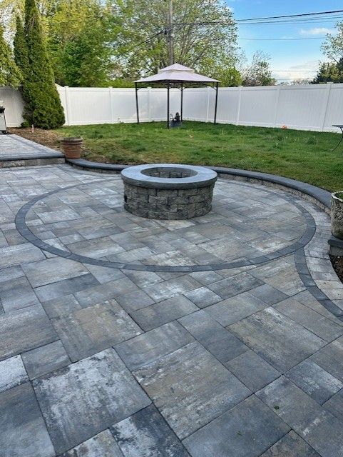 There is a fire pit in the middle of the patio.