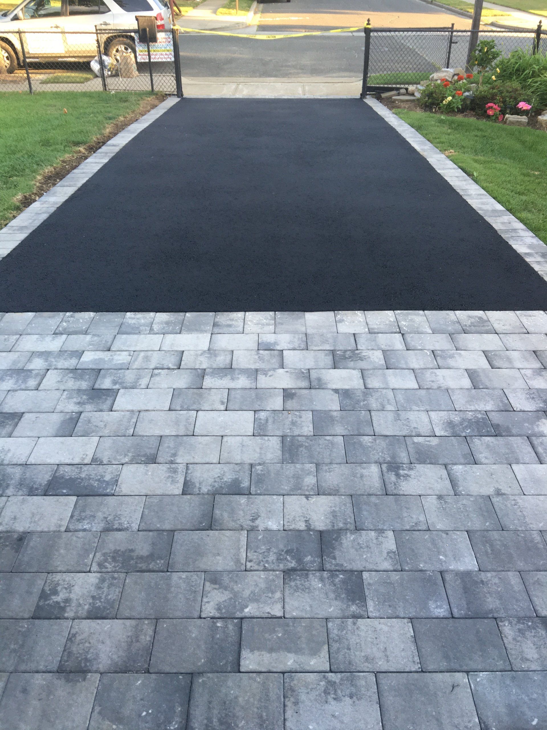 a driveway with a driveway and grass