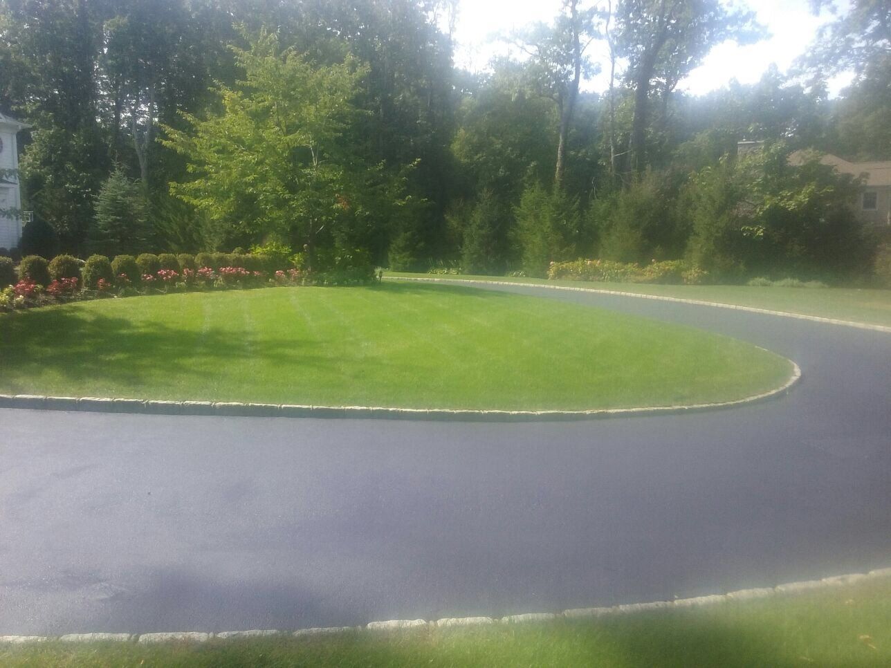 a road with a curved lawn