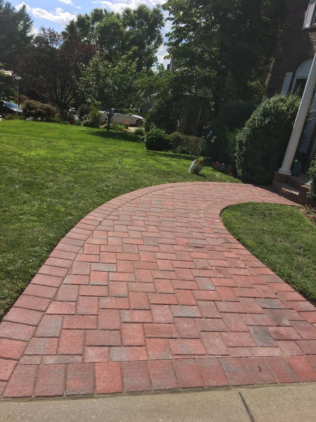 a brick walkway in a yard