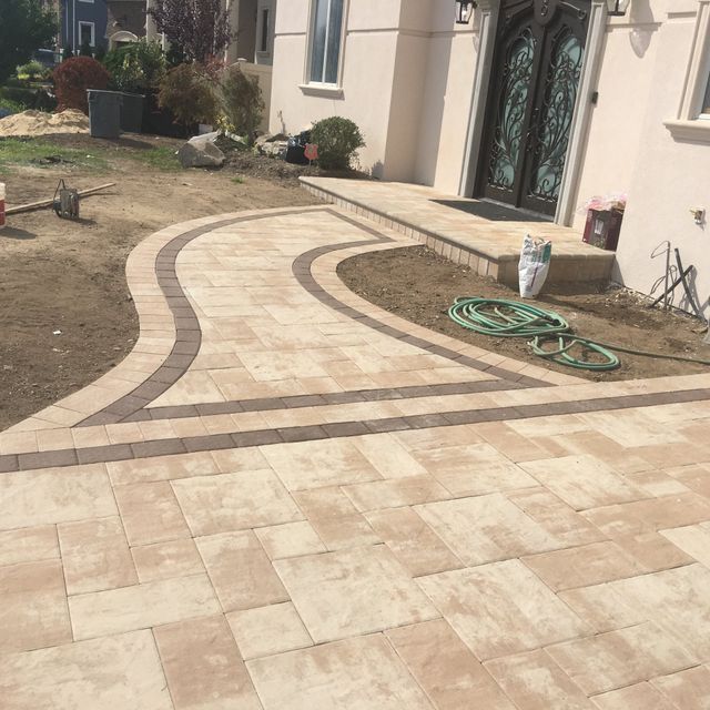 a brick walkway with a brick walkway and a building