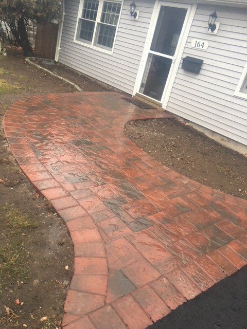 a brick walkway outside a house