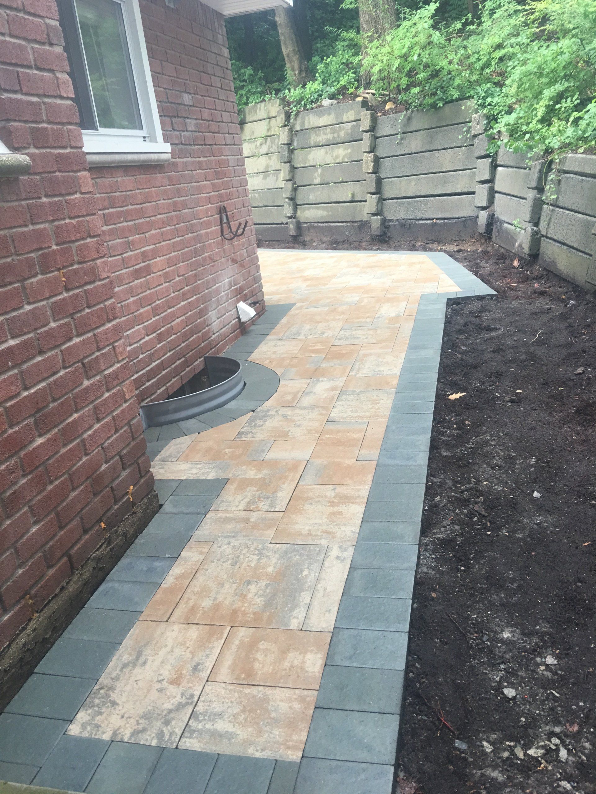 a brick walkway next to a brick building