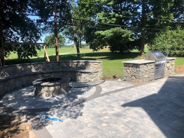 There is a fire pit in the middle of the patio.