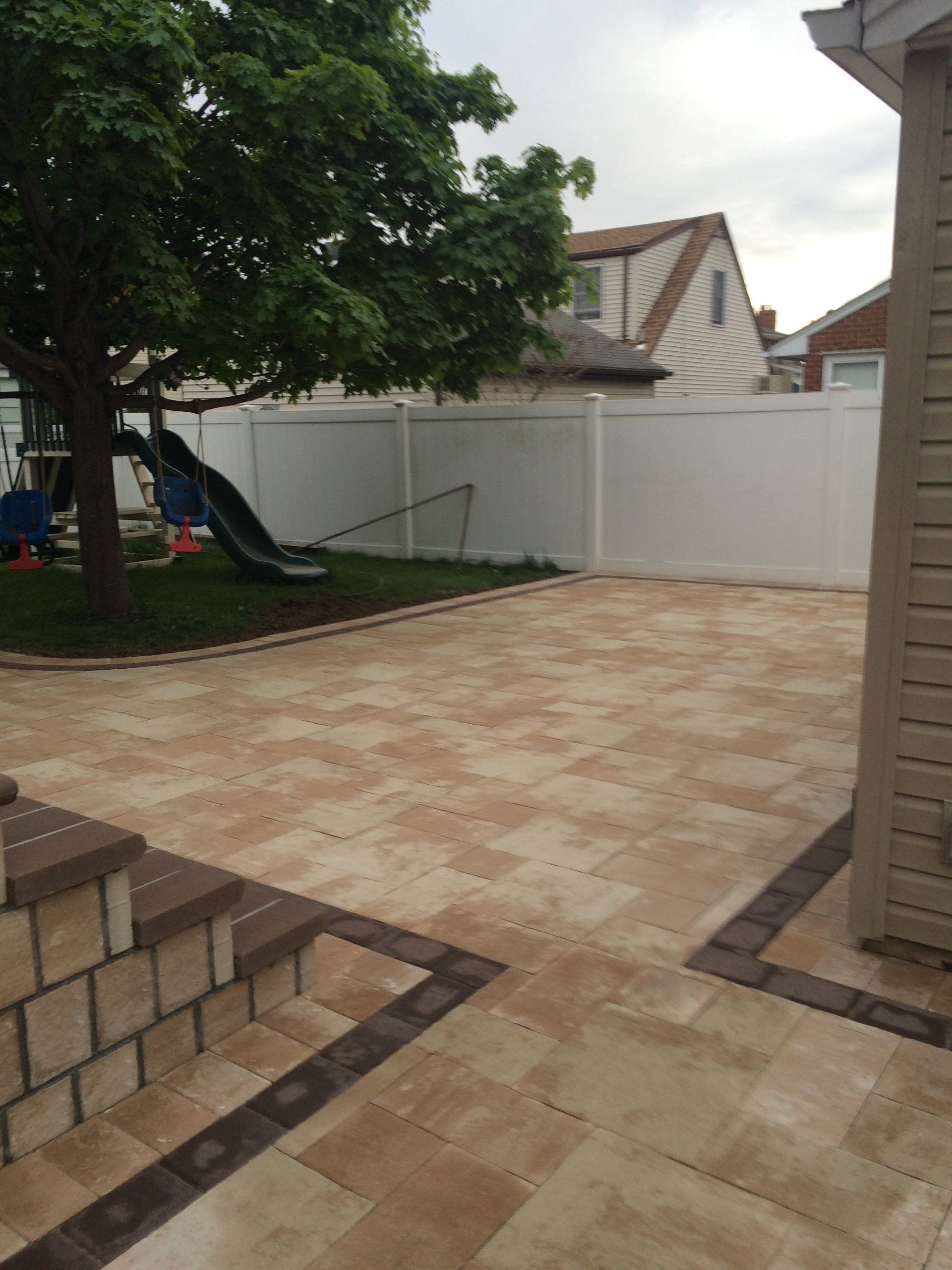 a backyard with a tree and a slide