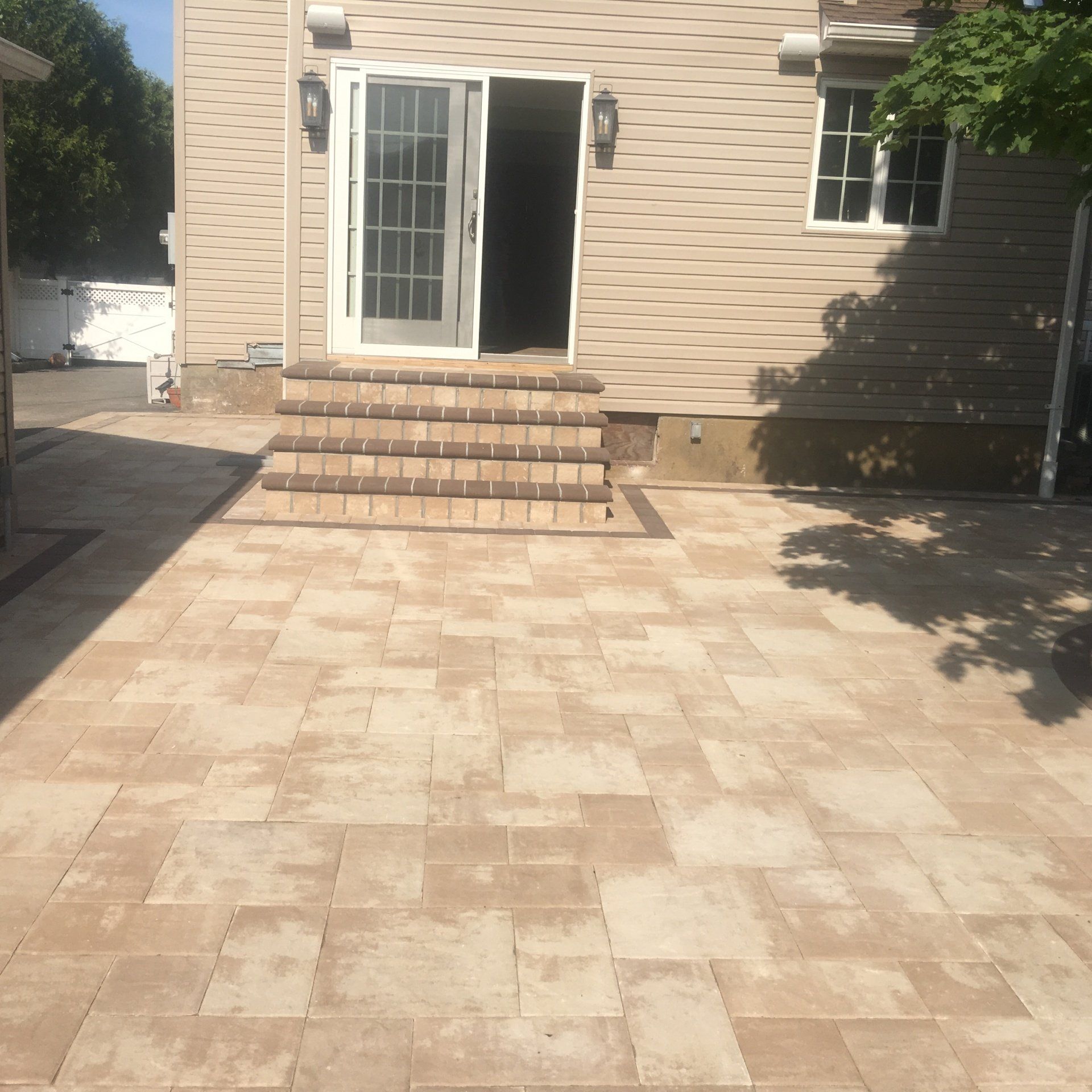 A patio with brick pavers and steps