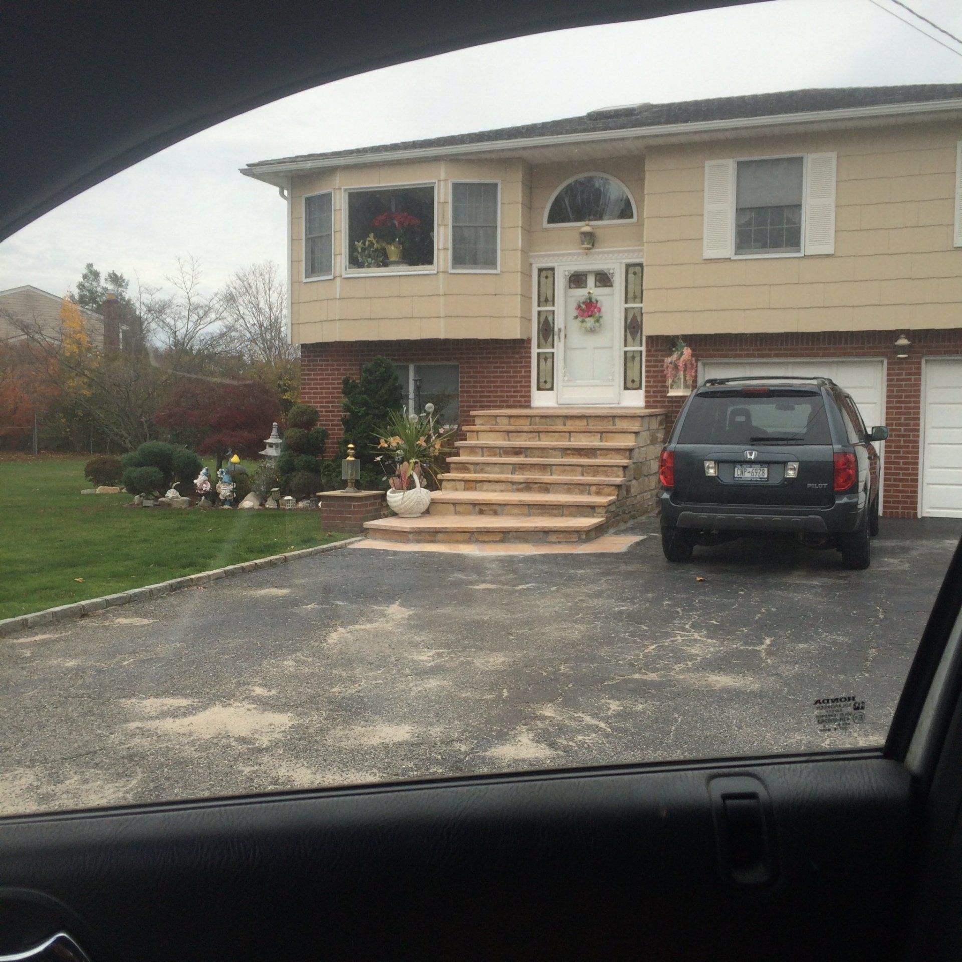 A patio with brick pavers with car parking