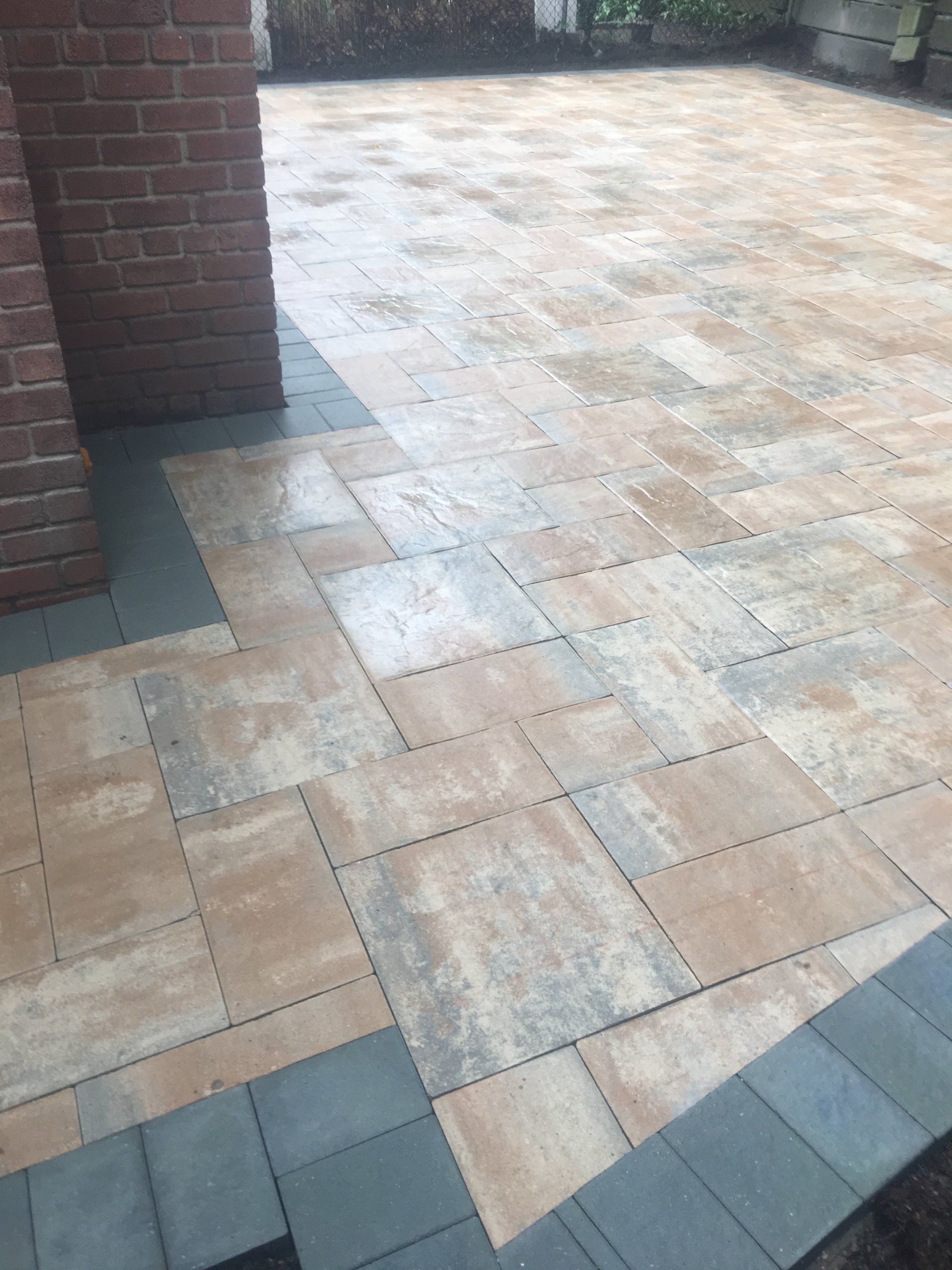 a brick patio with a brick column