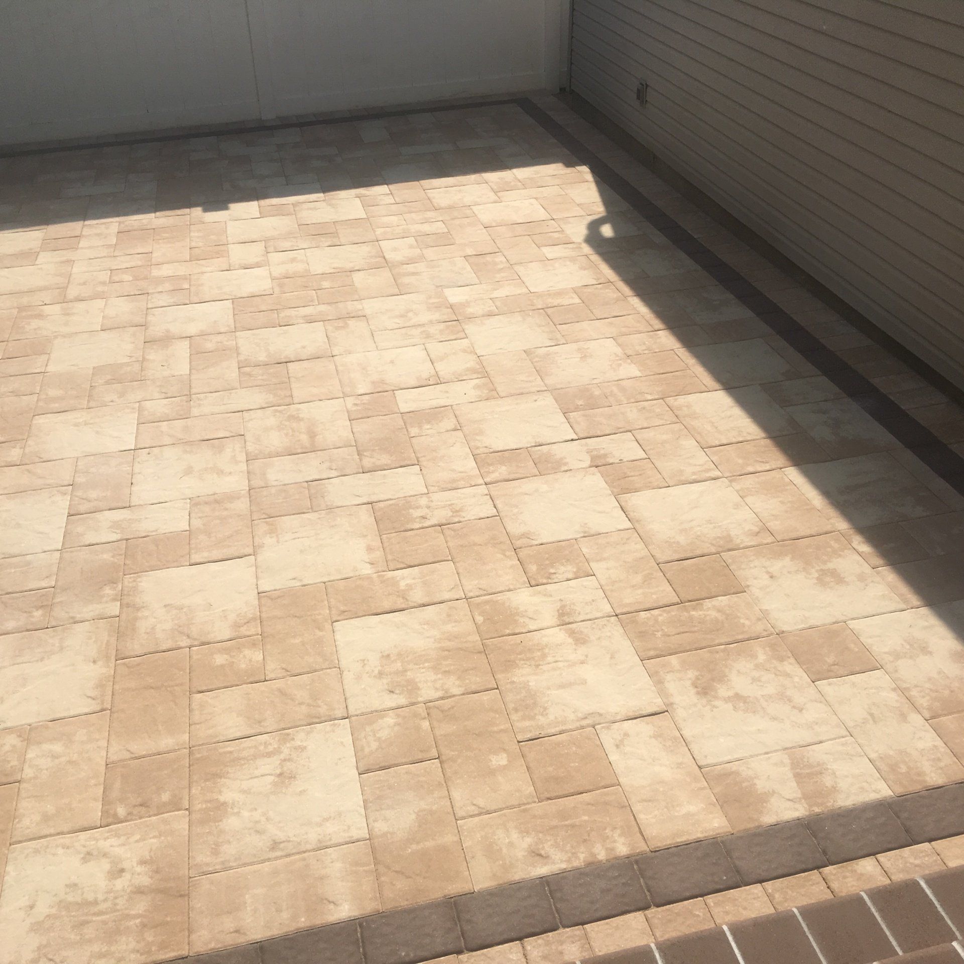 a brick patio with a garage door