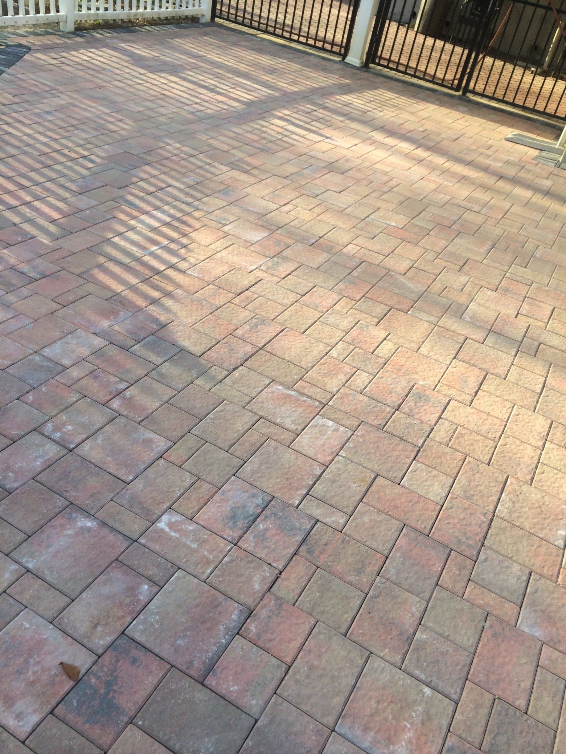 a brick patio with a fence