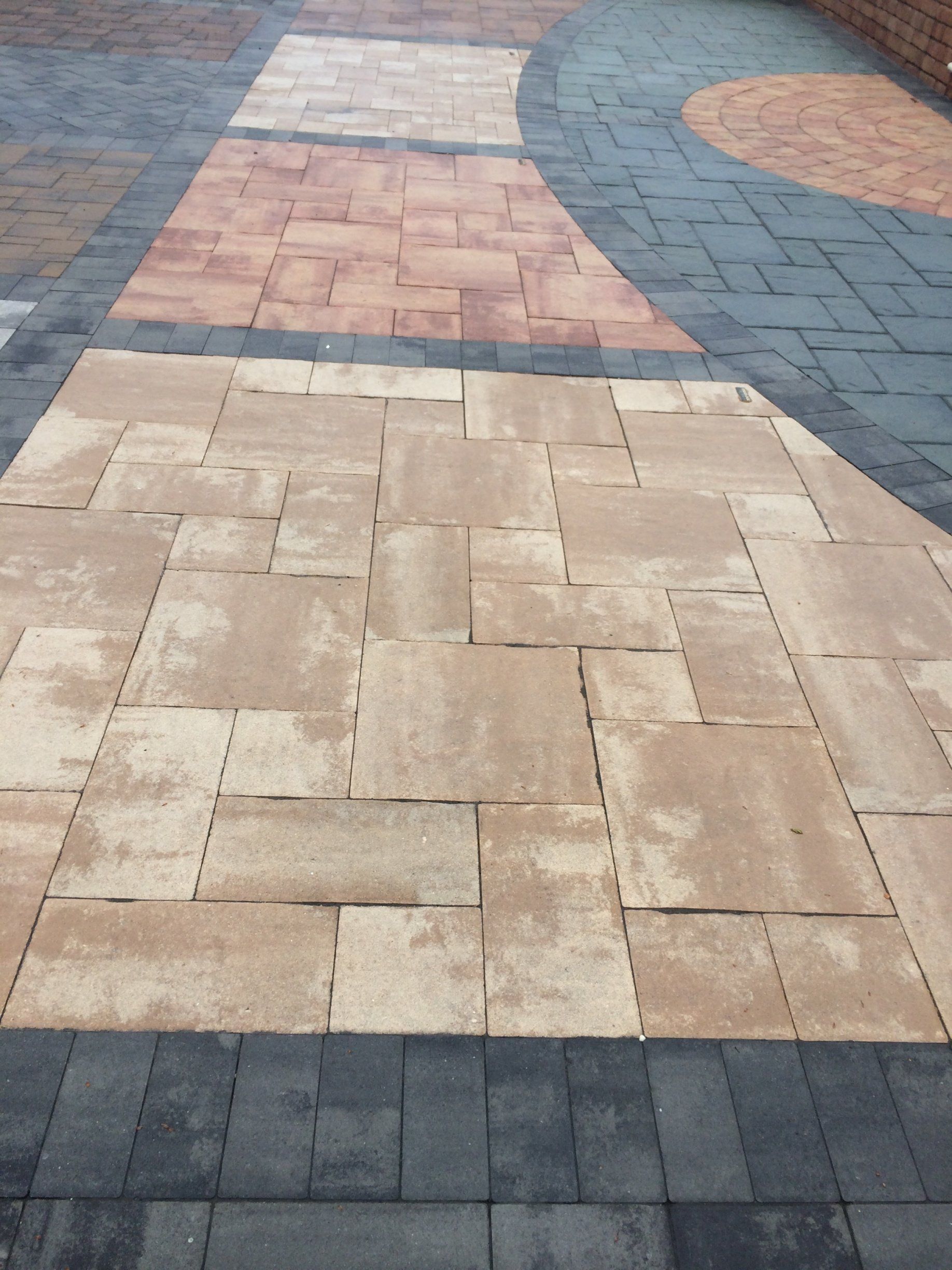 a brick walkway with different colors