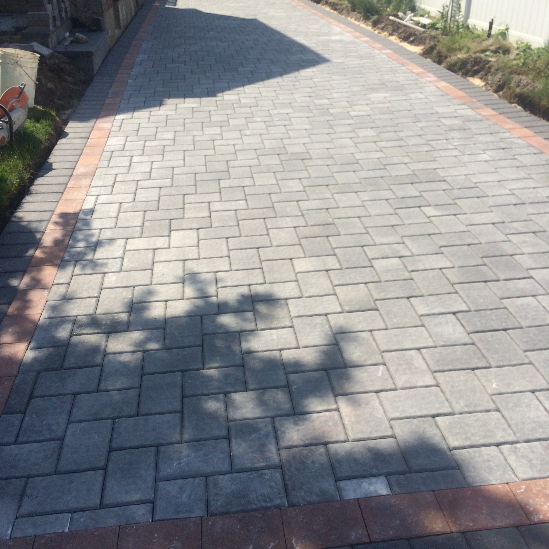 a brick walkway with a brick border