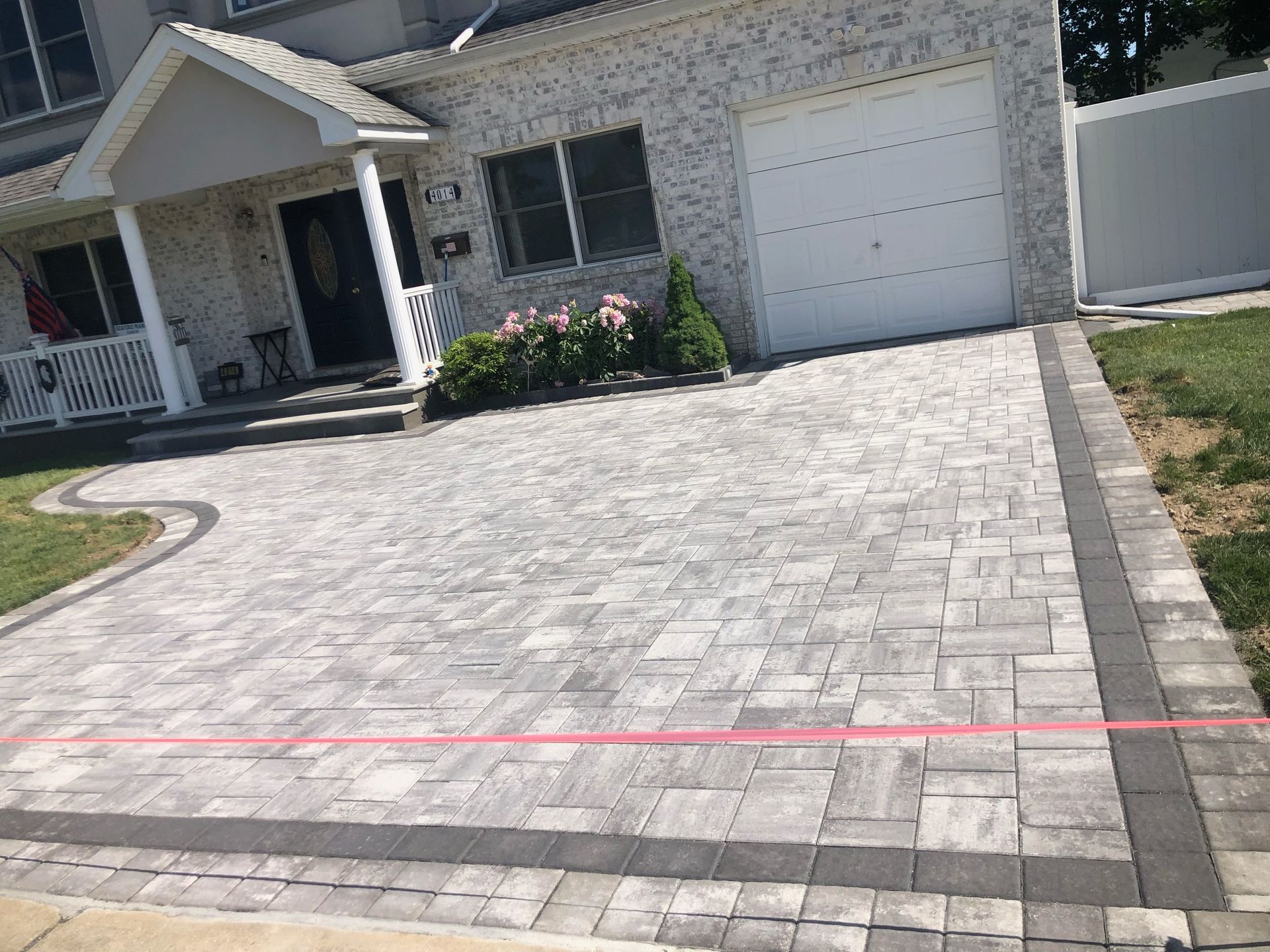 a brick driveway in front of a house