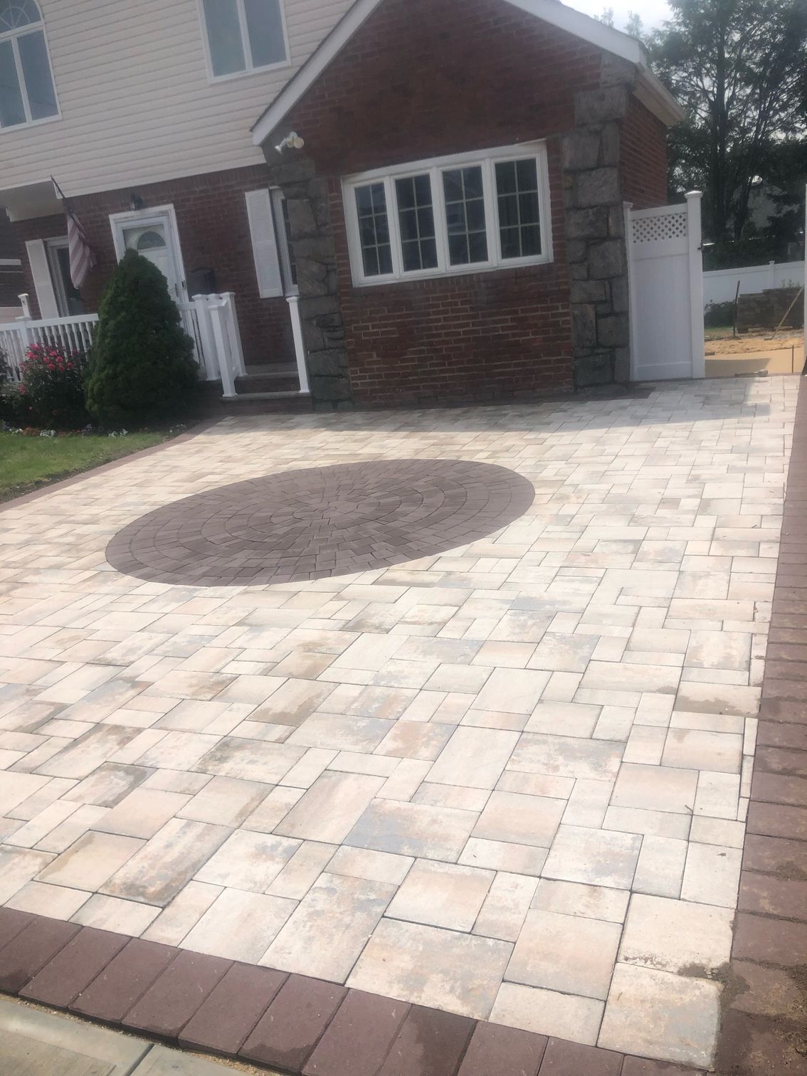 a brick house with a circular stone patio