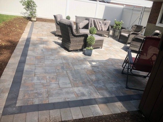 A patio with a couch and chairs on it