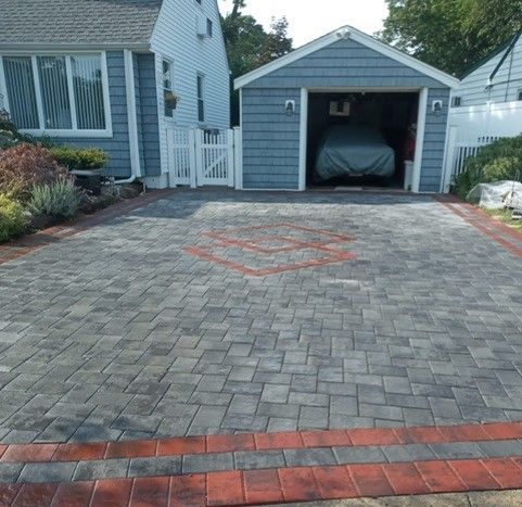 A car is parked in a garage in front of a house