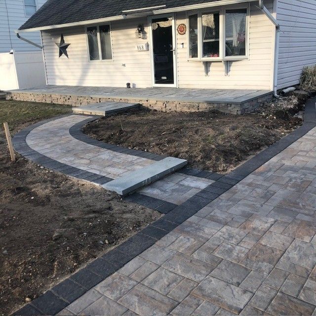 A white house with a walkway in front of it