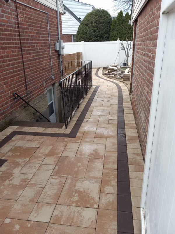 A brick house with a patio and stairs leading to it.