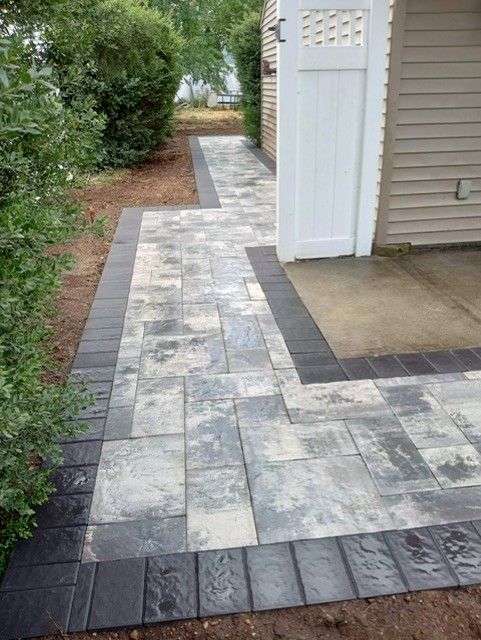 A walkway leading to a garage with a white door.