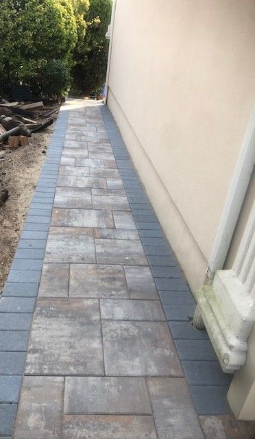 A sidewalk is being built in front of a house.