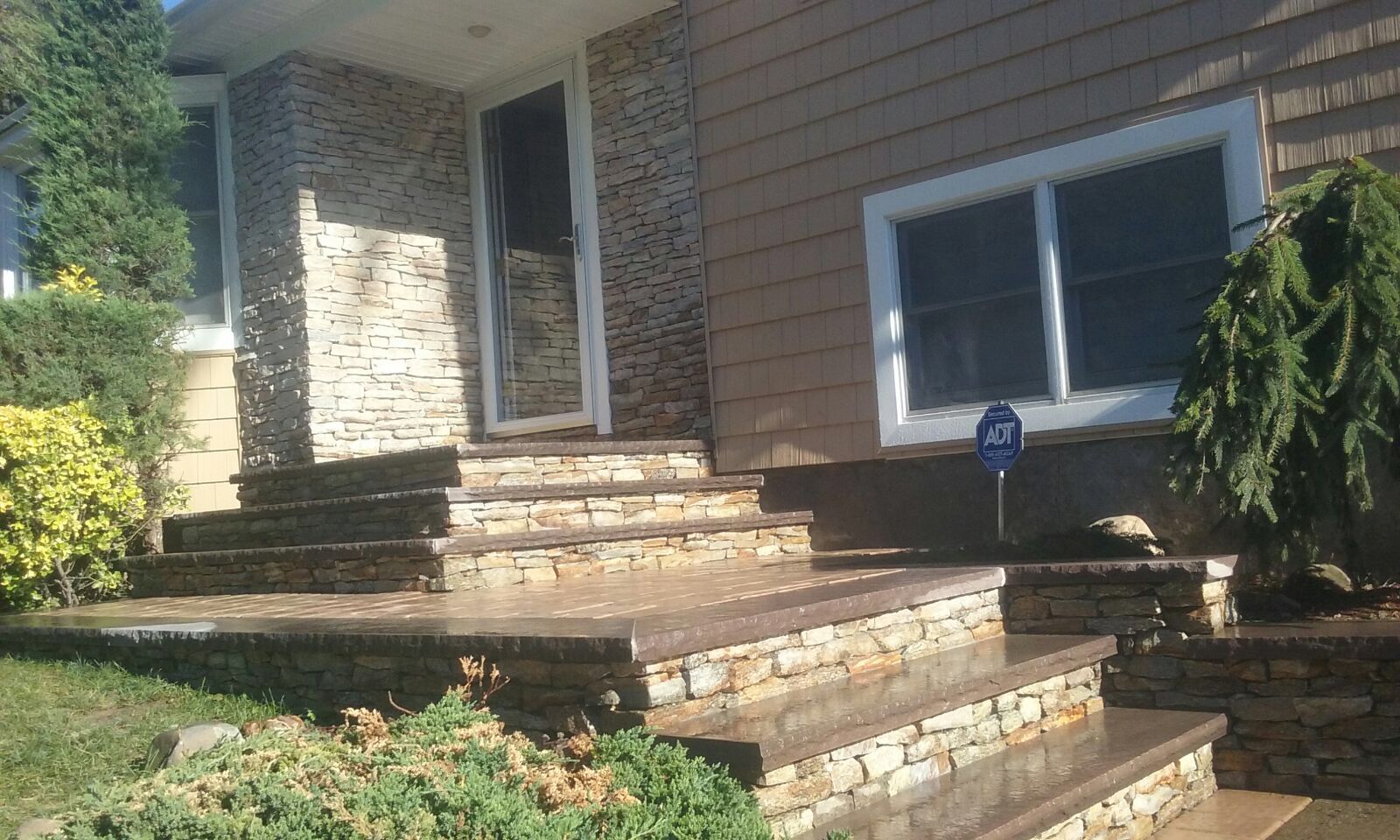 A house with stone steps leading up to the front door
