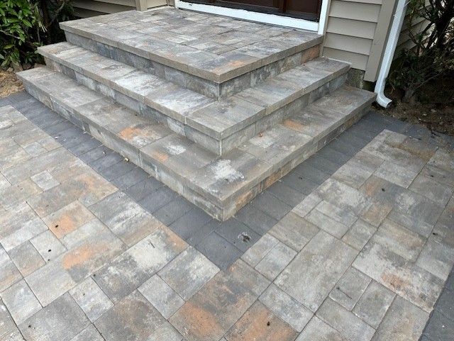 A set of steps leading up to a front door of a house.