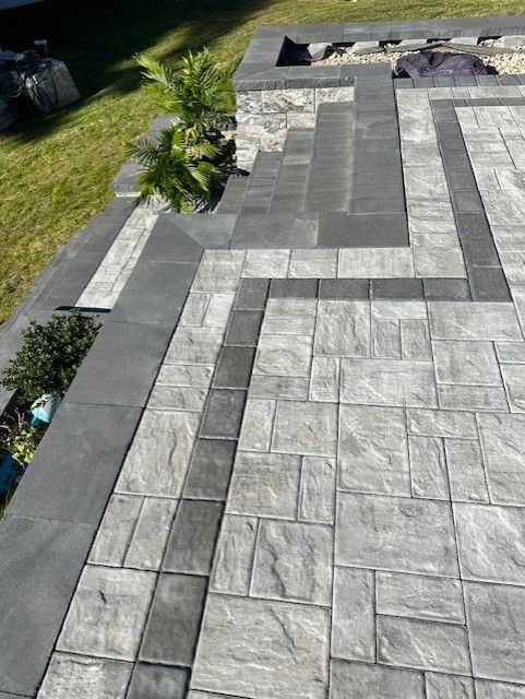 A patio with a fire pit in the middle of it.