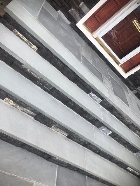 A close up of a staircase with a door in the background