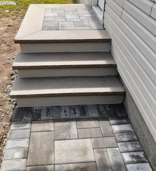 A set of stairs leading up to the side of a house