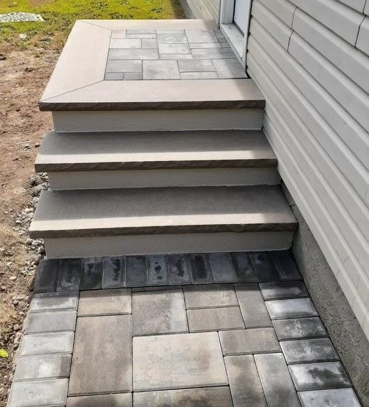 A set of stairs leading up to the side of a house.