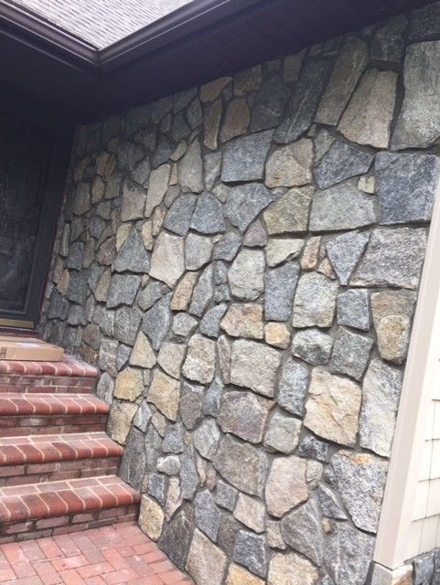 A stone wall with stairs leading up to it