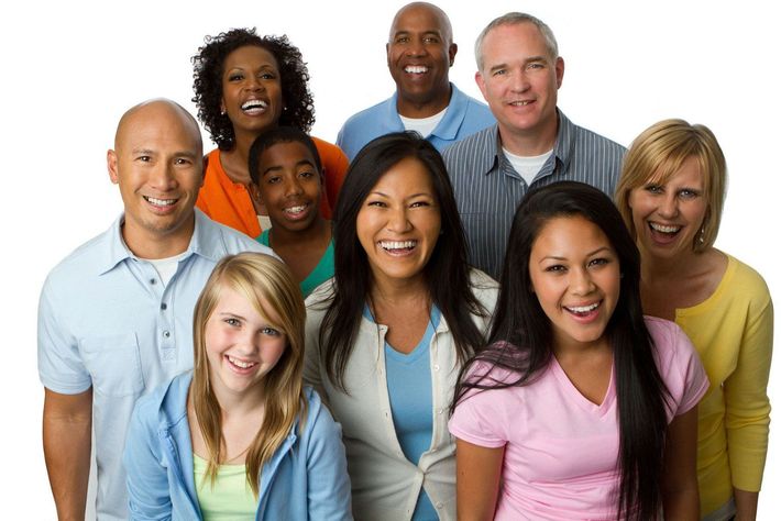 A group of people are posing for a picture and smiling