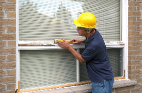 A man repairing a window