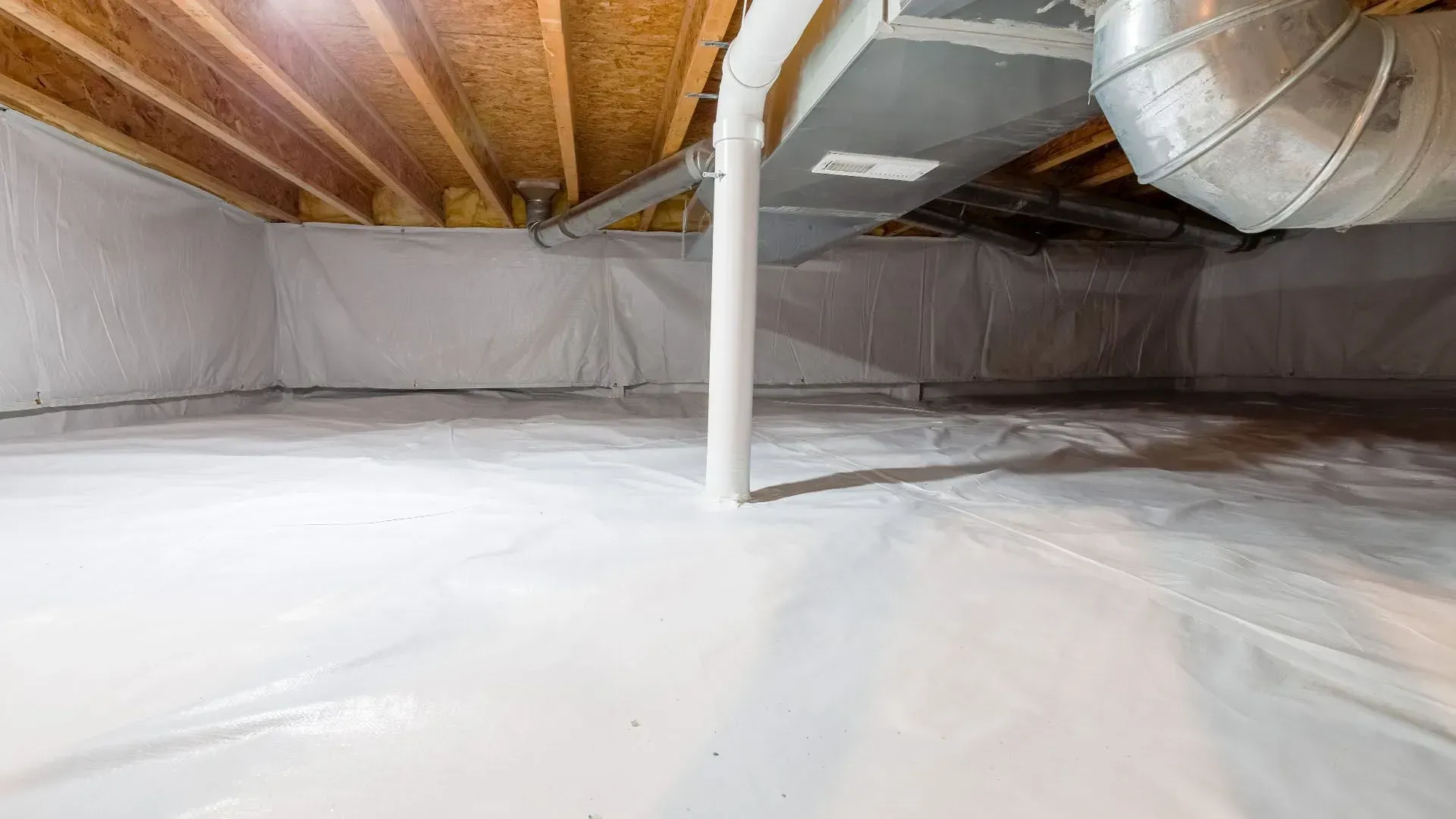 Crawlspace with white vapor barrier, exposed wooden joists, and HVAC ductwork overhead