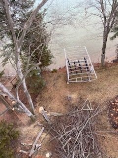 An aerial view of a dock on the shore of a lake