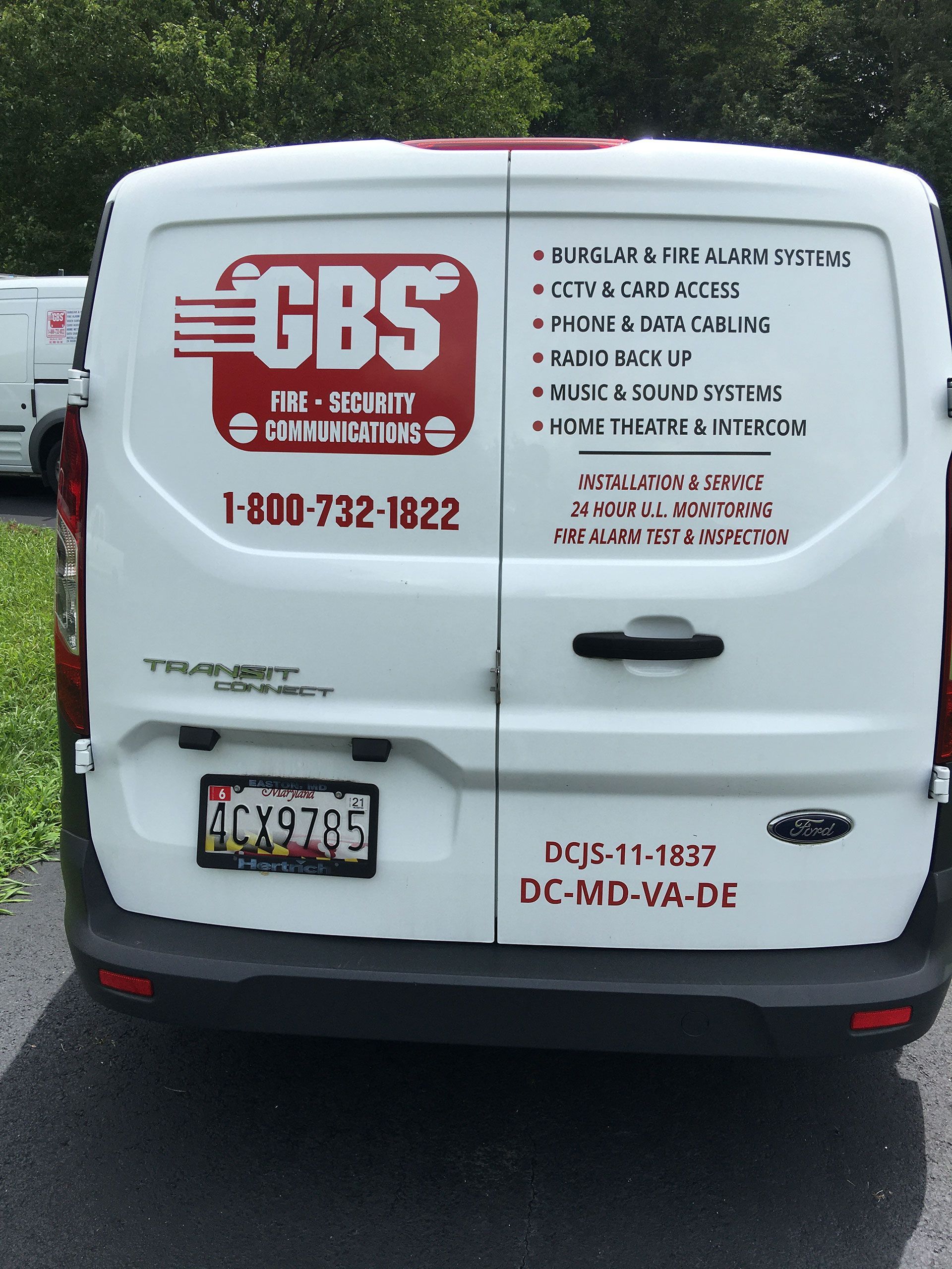 A white van with gbs written on the back