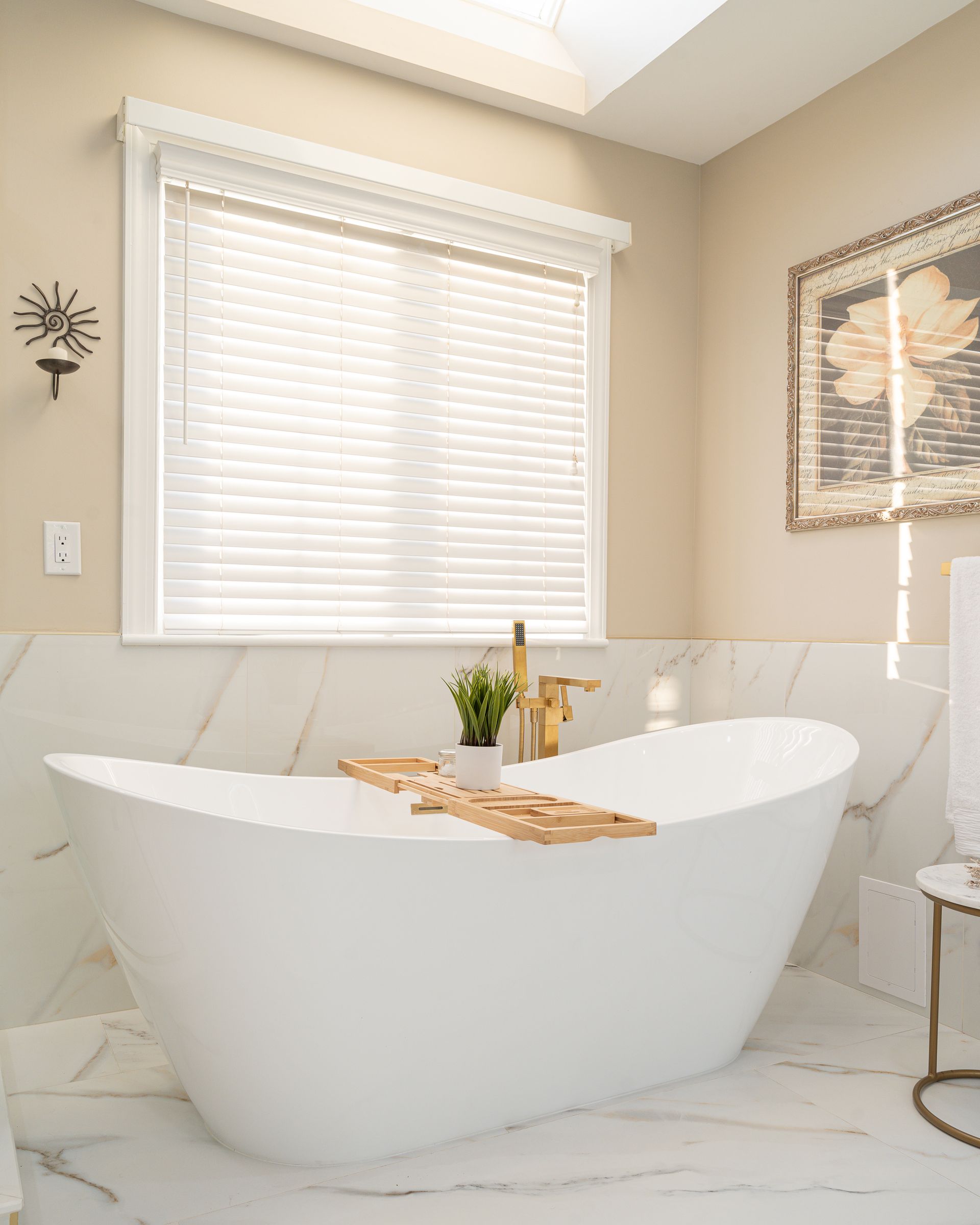 A bathroom with a white bathtub and a window.