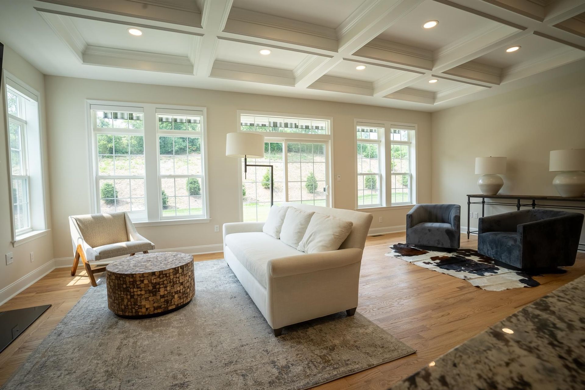 A living room with a couch, chairs, and a coffee table