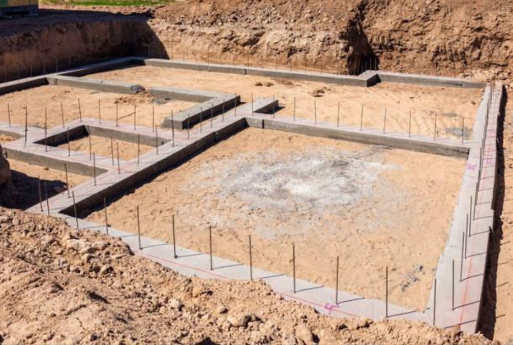 Concrete foundation framework laid in an excavated building site.