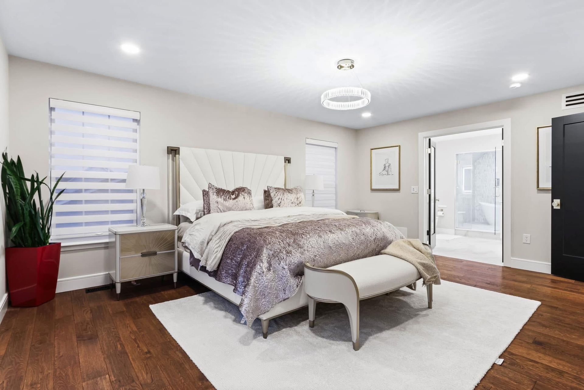 A bedroom with a king-size bed and a bench.