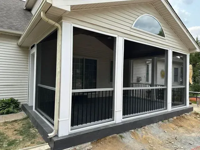 A screened in porch is being built on the side of a house