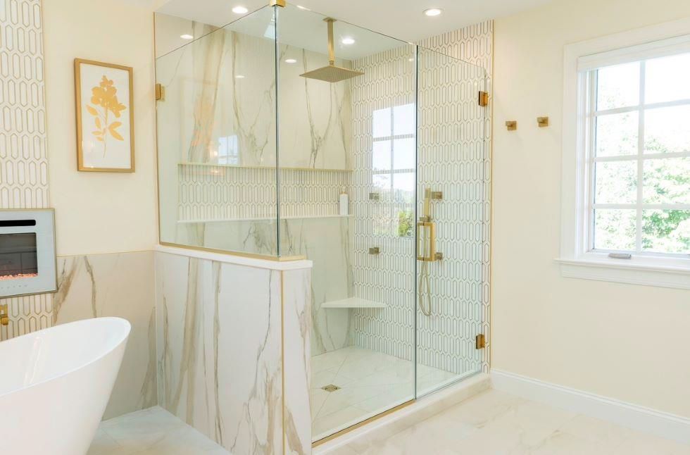A bathroom with a walk in shower and a tub