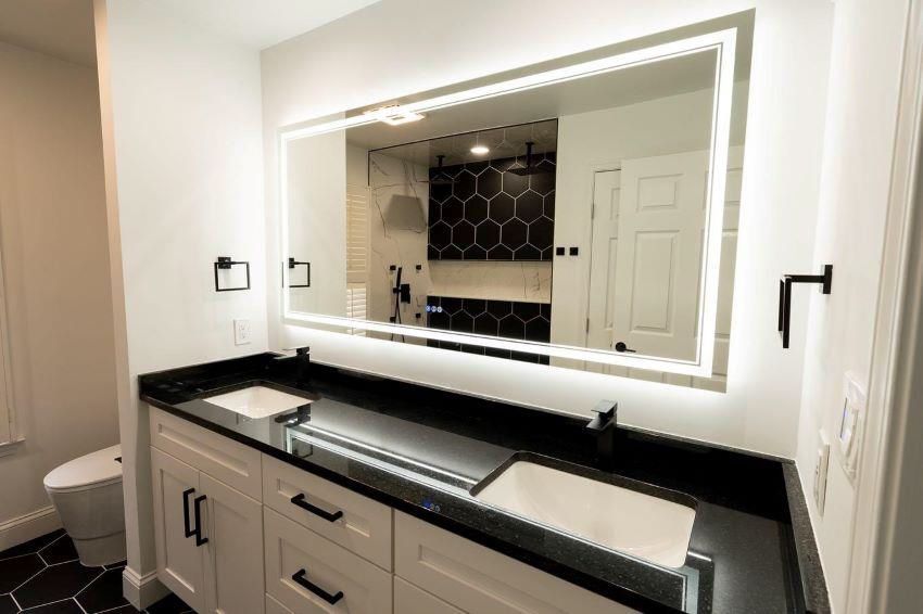 A bathroom with two sinks and a large mirror