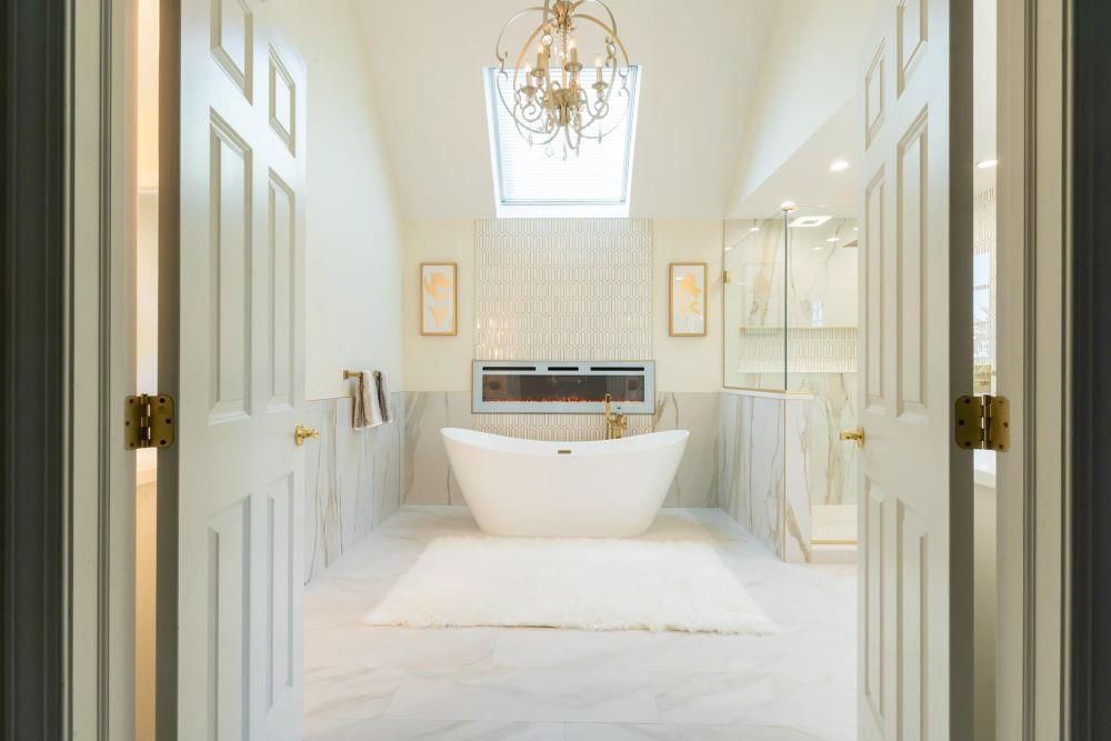 A bathroom with a bathtub and a chandelier hanging from the ceiling