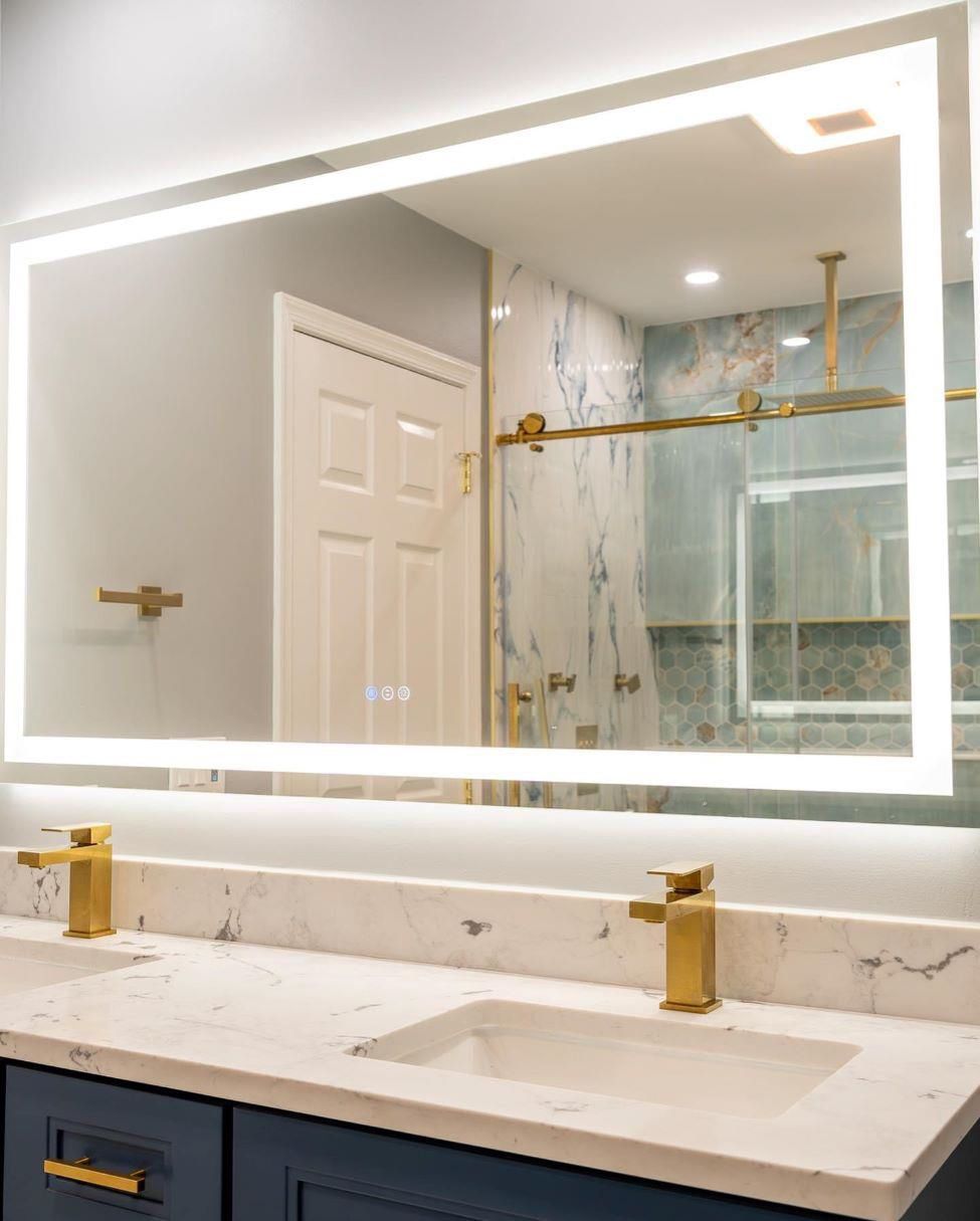 A bathroom with two sinks and a large mirror