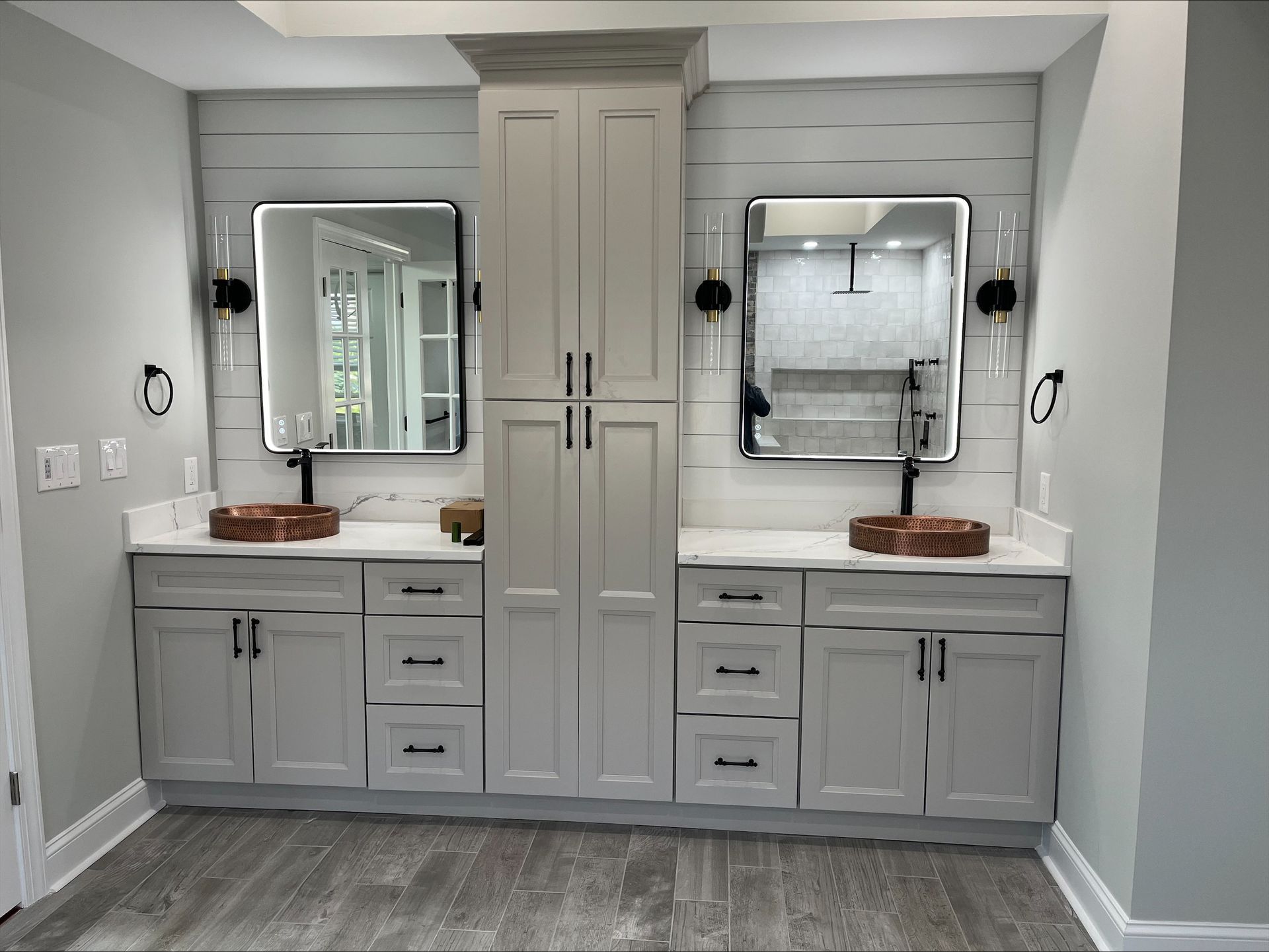 A bathroom with two sinks and two mirrors.