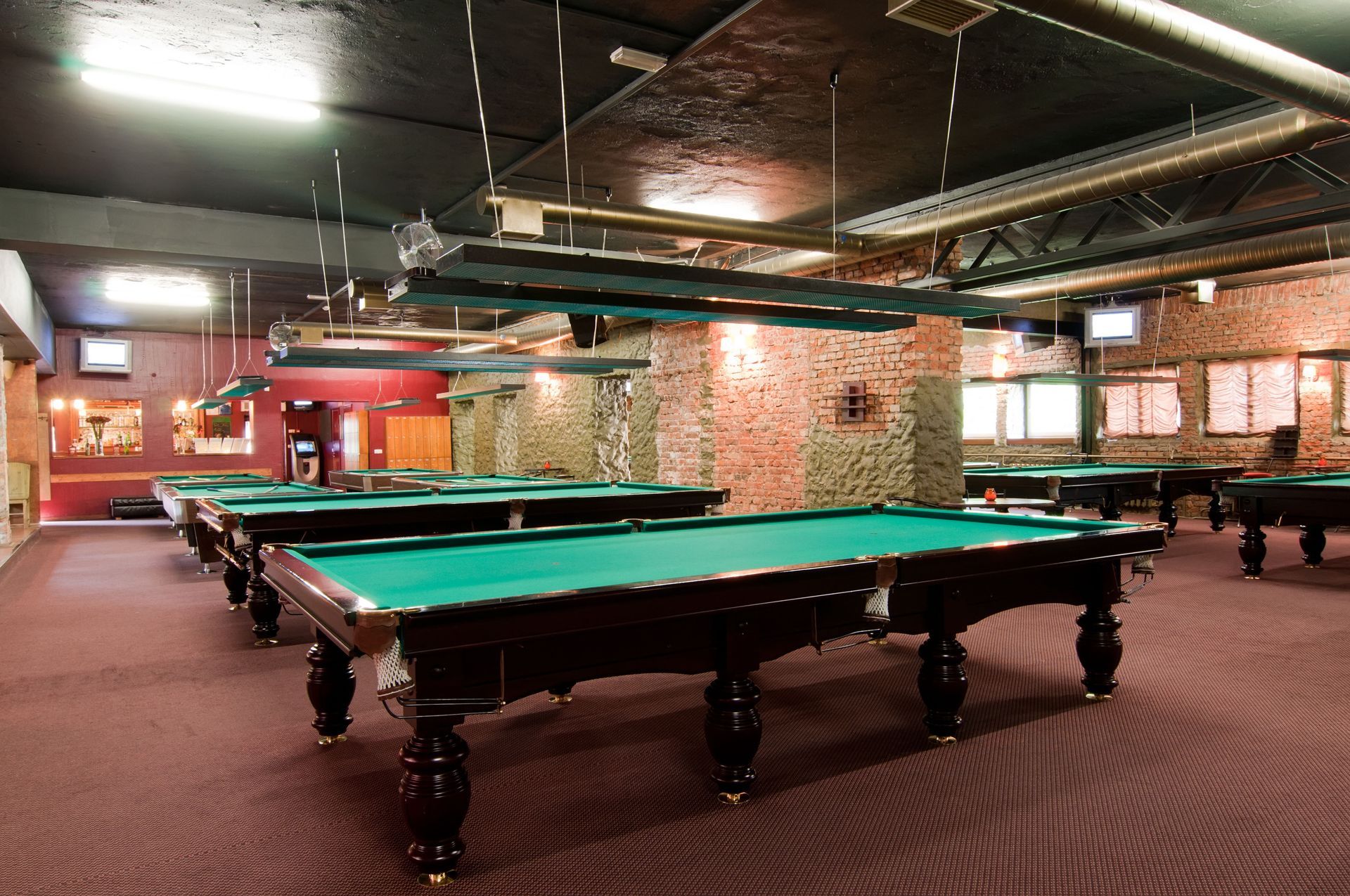 A pool hall with a lot of pool tables