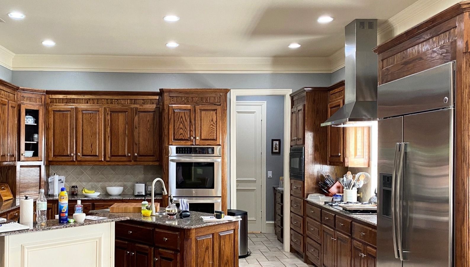 Kitchen with wood cabinets, stainless steel appliances, and island.