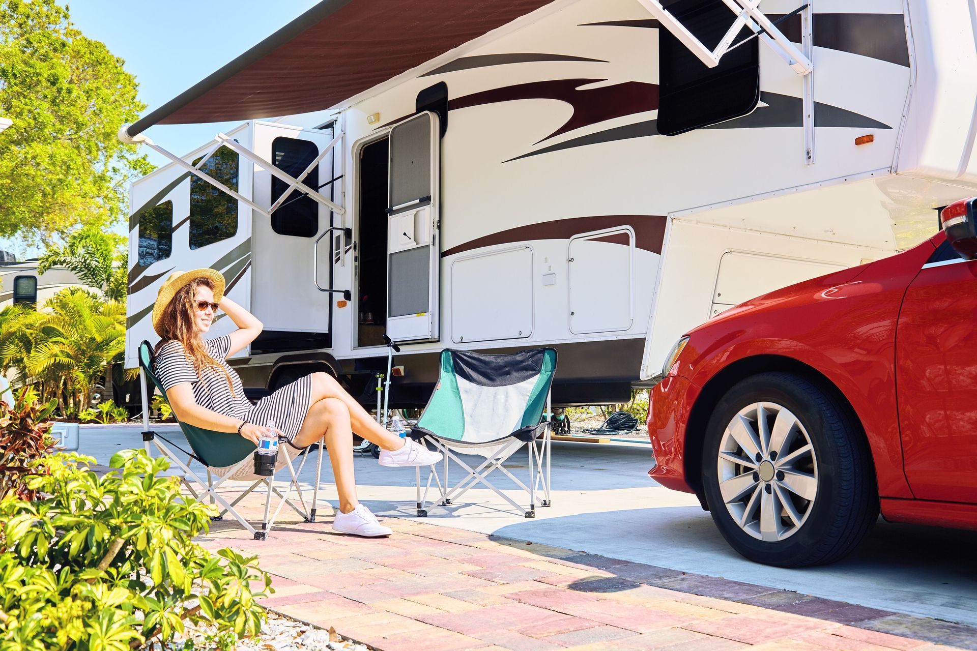 Wedding reception tent with purple draped fabric, white tables, and chairs.
