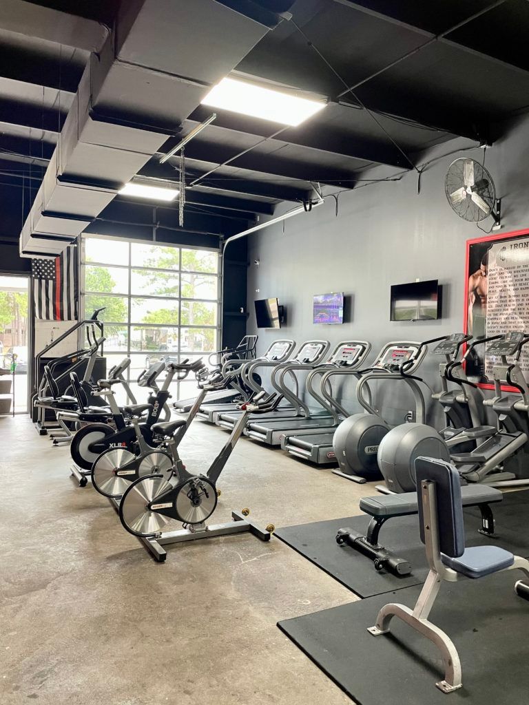 A gym filled with lots of exercise equipment and bikes.